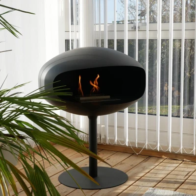 Cocoon Pedestal - Black with a Black Base, a freestanding bioethanol fireplace with a modern design and eco-friendly heating.