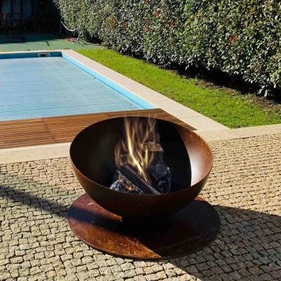 GlammFire Solace outdoor firepit in corten steel with a rust-like finish, perfect for patios and gardens.
