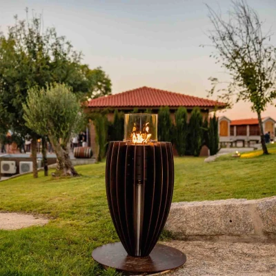 Tuli Gas Heater by GlammFire in Corten Steel, a stylish outdoor gas fireplace with a rust-like finish.