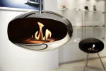 Cocoon Aeris Polished Steel ceiling-mounted bioethanol fireplace with a sleek steel pole, offering modern elegance and efficient