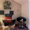 Cocoon Pedestal - Black with a Black Base, a freestanding bioethanol fireplace with a modern design and eco-friendly heating.
