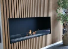 Foco One 1000 bioethanol fireplace by FOCO Fires, a sleek built-in one-sided fireplace with remote control and black finish.