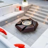 Stravaganza firepit by GlammFire in lacquered corten steel, a luxury outdoor fire feature with a rust-toned finish.