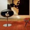 Cocoon Pedestal Matte Black with Steel Pedestal - A modern floor-standing bioethanol fireplace with a sleek design and stainless