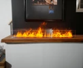 Mistero 1000 Water Vapour Fireplace by Magic Fire with a sleek black finish and realistic flame effect.