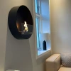 Delaware S Round Design Fireplace by ScandiFlames, a sleek Ø50 cm wall-mounted bioethanol fireplace in black.