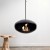 Cocoon Aeris Black with Steel Mounting Pole – a modern ceiling-mounted bioethanol fireplace with a sleek black finish and durabl