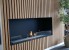 Foco One 1000 bioethanol fireplace by FOCO Fires, a sleek built-in one-sided fireplace with remote control and black finish.
