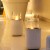 Planika Jar with Concrete Base – Stylish freestanding bioethanol fireplace in white with a concrete base for outdoor use.