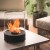 Chantico Glassfire tabletop bioethanol fireplace in black with glass panels, offering modern design and efficient heating.