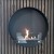 Delaware Black Round Wall Mounted Biofireplace by ScandiFlames - A modern, space-saving bioethanol fireplace with a sleek black