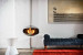 Cocoon Aeris Polished Steel ceiling-mounted bioethanol fireplace with a sleek steel pole, offering modern elegance and efficient